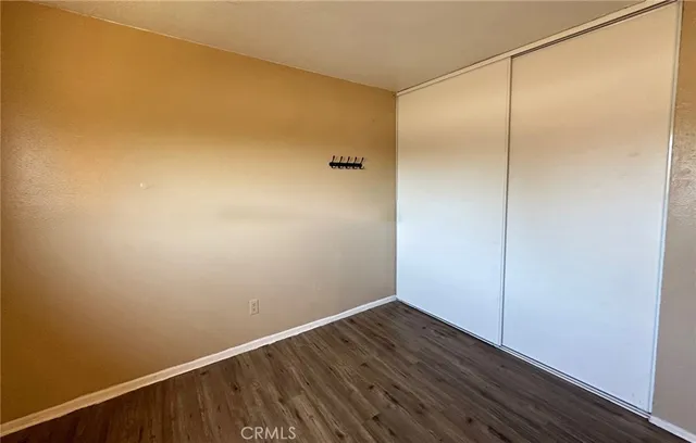 a view of a small space with wooden floor and a window