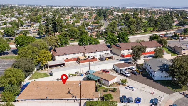 an aerial view of a house with a yard