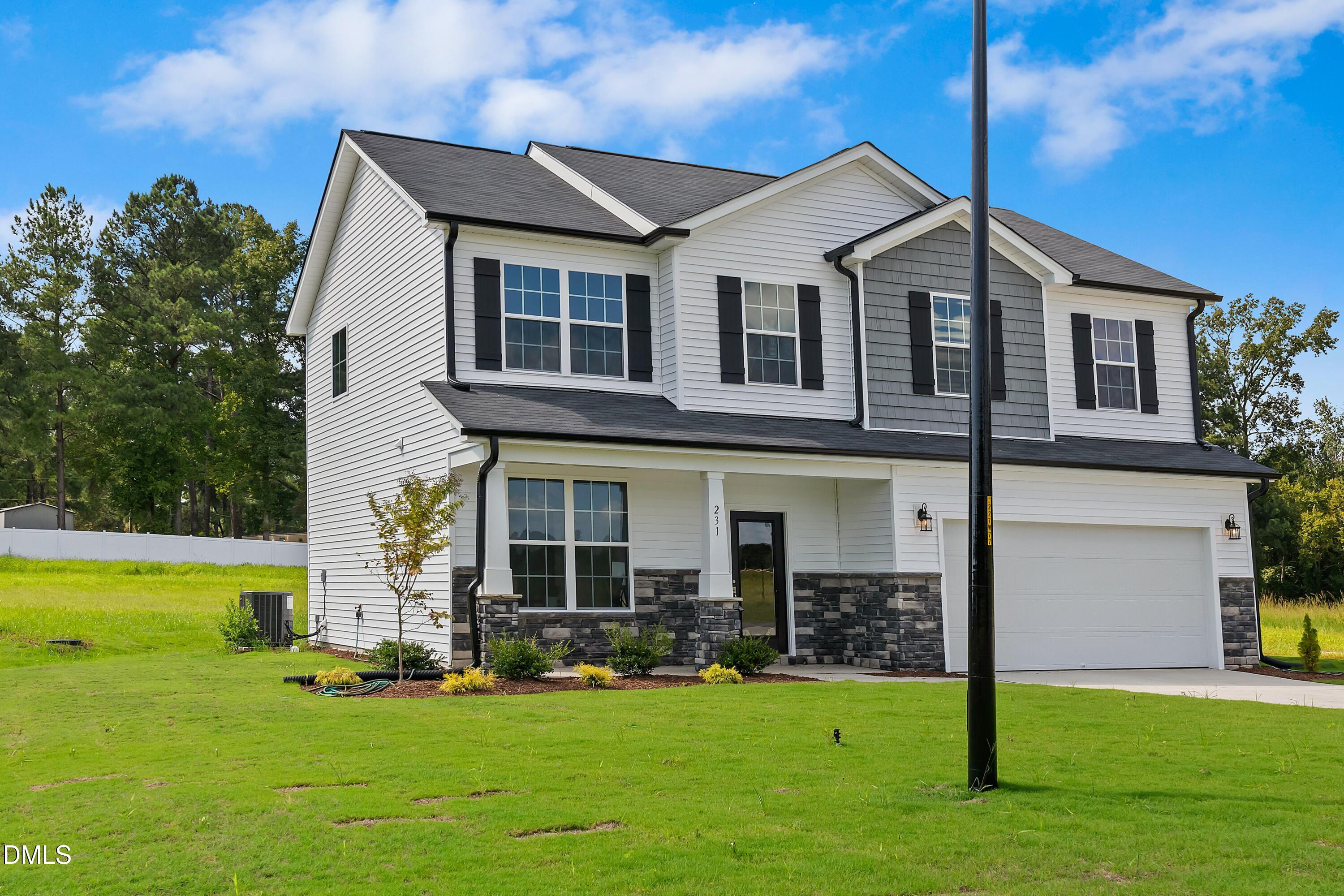 124 Starlet Ridge Way Clayton, NC 27520 - Photo 2 of 36 a front view of a house with a yard