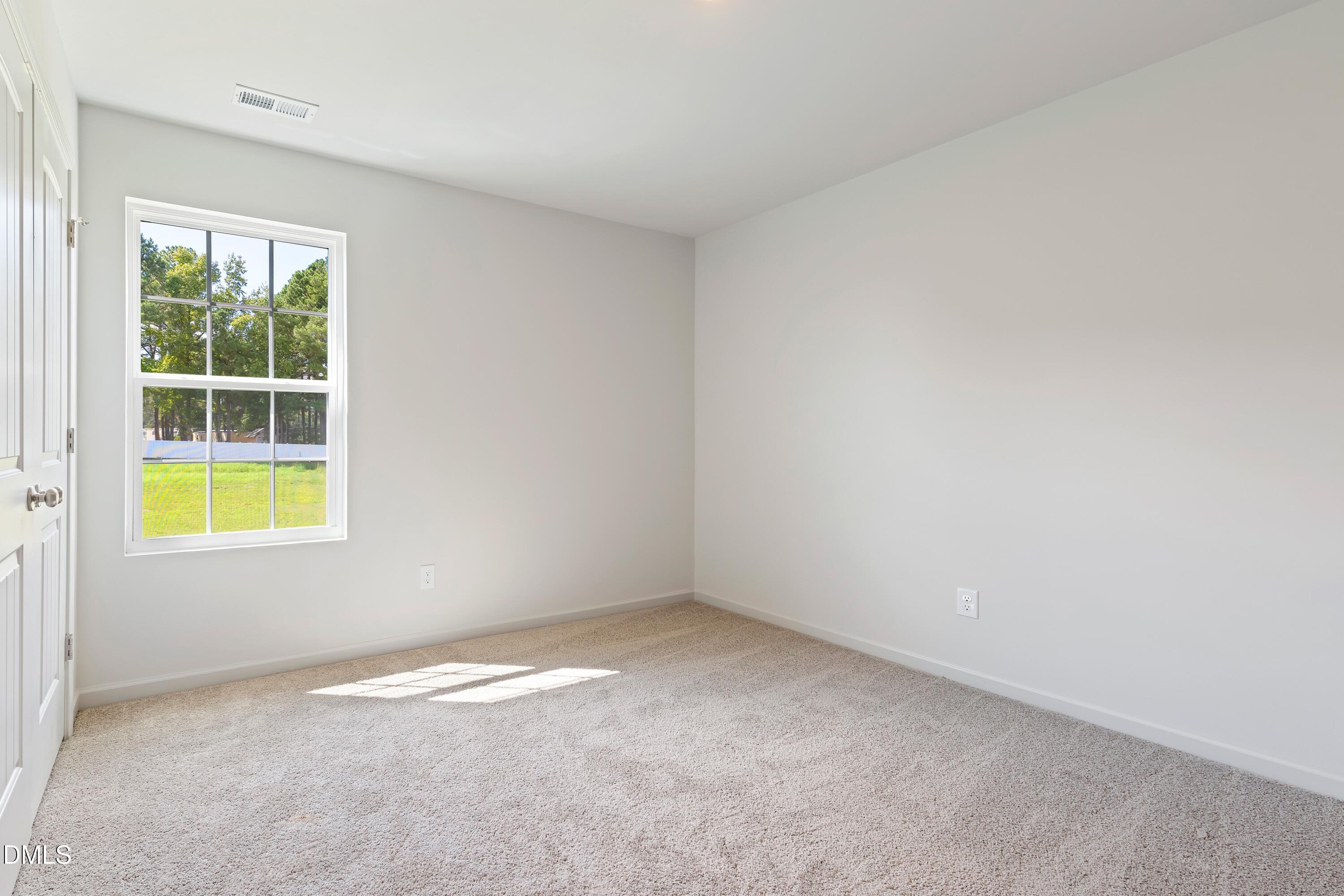 124 Starlet Ridge Way Clayton, NC 27520 - Photo 22 of 36 an empty room with a window