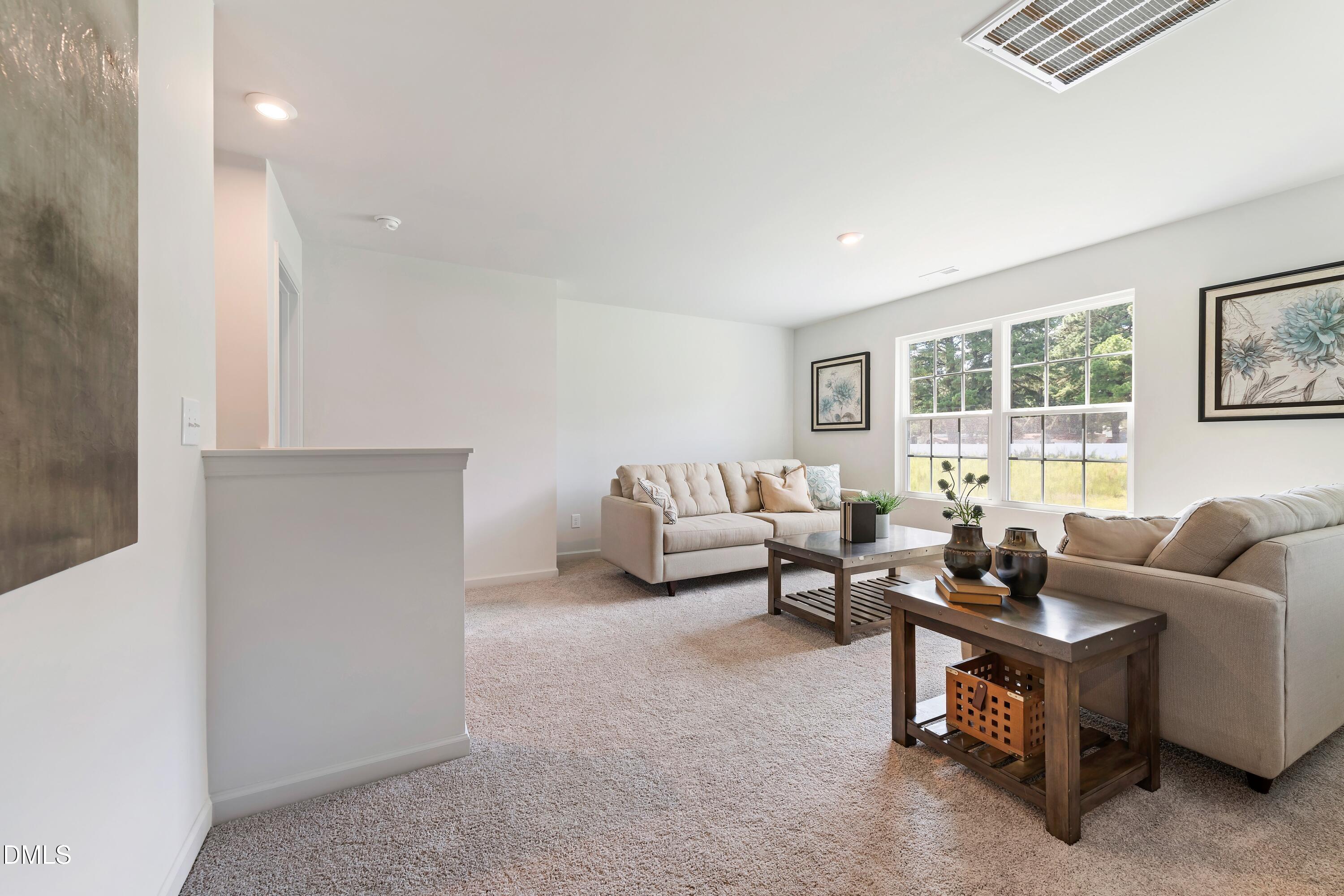 124 Starlet Ridge Way Clayton, NC 27520 - Photo 24 of 36 a living room with furniture and a window