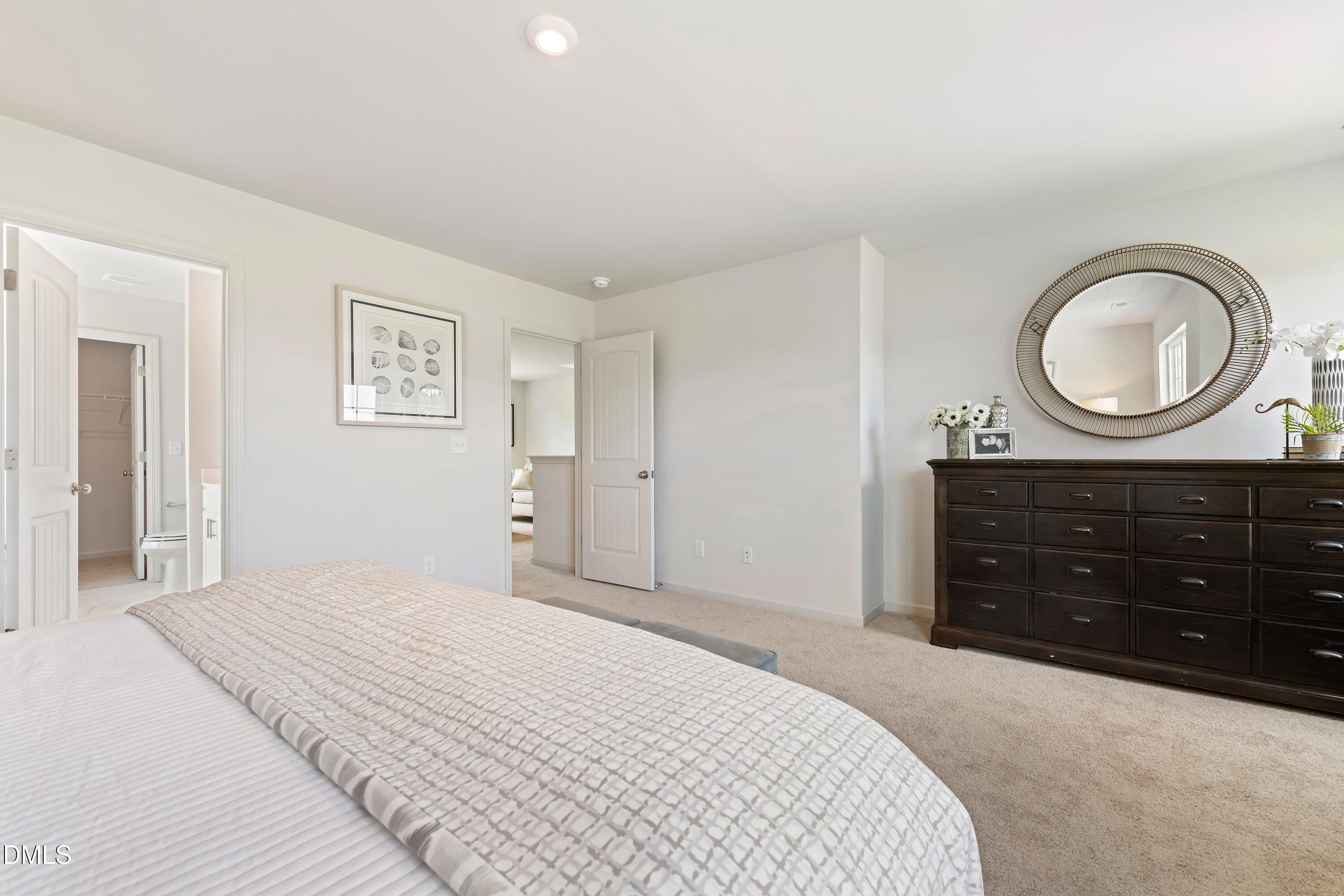 124 Starlet Ridge Way Clayton, NC 27520 - Photo 28 of 36 a bedroom with a bed and a dresser