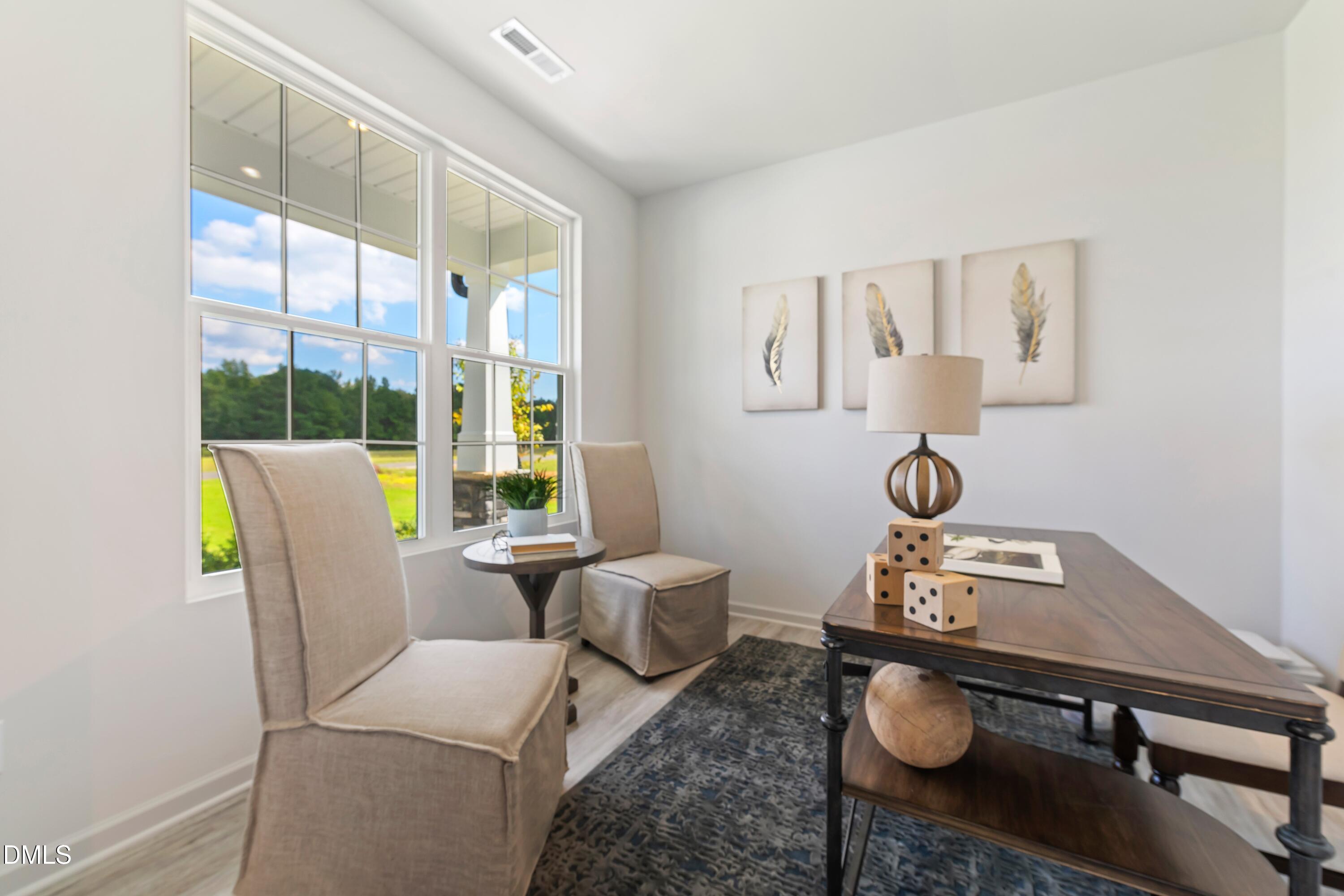 124 Starlet Ridge Way Clayton, NC 27520 - Photo 7 of 36 a living room with furniture and wooden floor