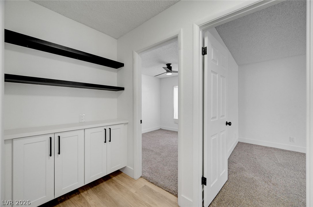 4840 Summerhill Road Las Vegas, NV 89121 - Photo 25 of 56 Functional built-in cabinetry and shelving provide convenient storage solutions in this well-appointed hallway.