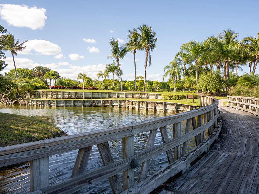 2139 Falls Circle Vero Beach, FL 32967 - Photo 5 of 17 a view of a swimming pool and lake from a bench