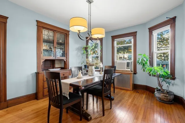 a view of a dining room with furniture window and wooden floor