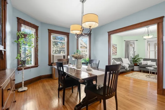 a view of a dining room with furniture window and wooden floor