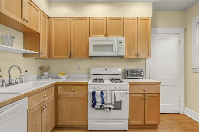 a kitchen with a sink a stove and cabinets