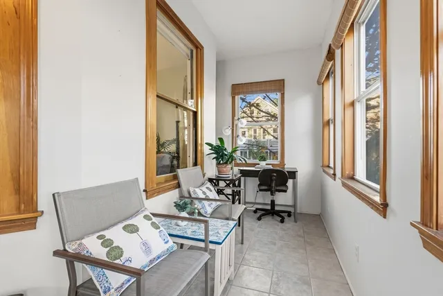 a living room with furniture a flat screen tv and a window