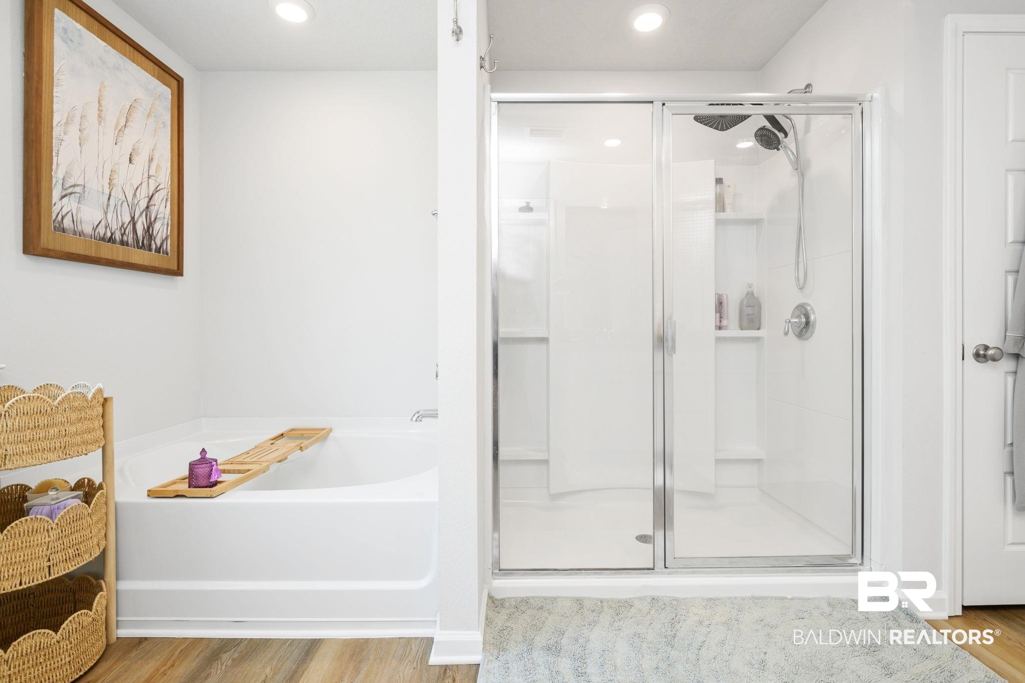 8021 Valor Rdg Way North Mobile, AL 36619 - Photo 30 of 34 Bathroom featuring a white soaking tub, a separate glass-enclosed shower with a showerhead and handheld sprayer, and wood-finish flooring