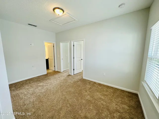 an empty room with windows and entrance