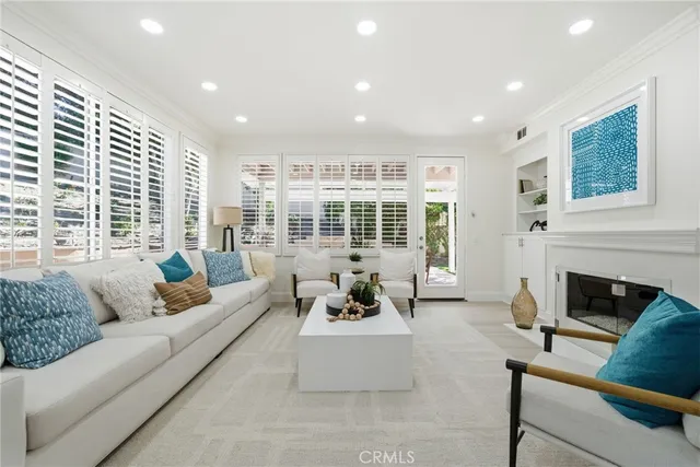 a large kitchen with stainless steel appliances and white cabinets
