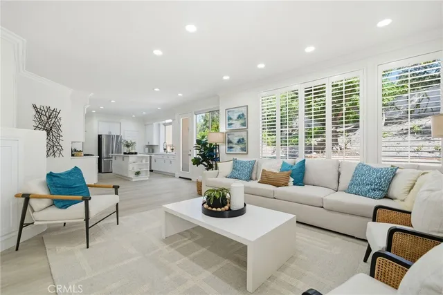 a kitchen with a sink dishwasher stove and white cabinets with wooden floor