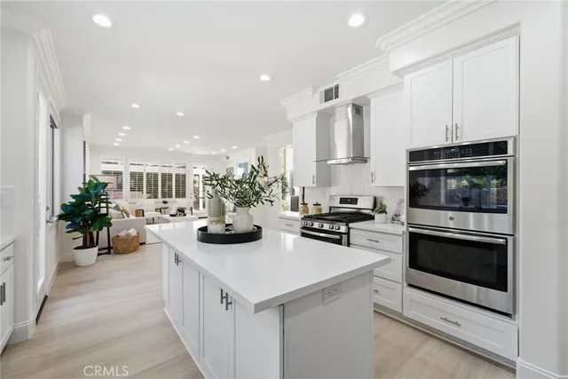 a living room with furniture a chandelier and a dining table