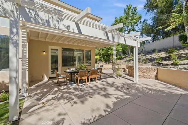 a bedroom with a white bed and a couch with window