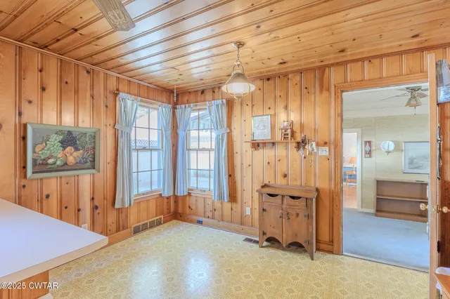 a large kitchen with a large window and stainless steel appliances