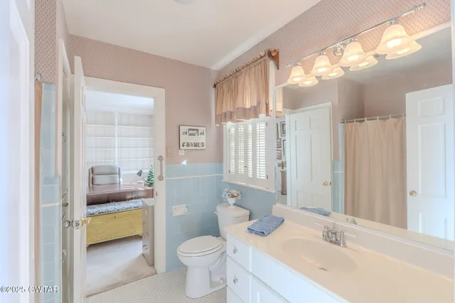 a bathroom with a toilet and shower