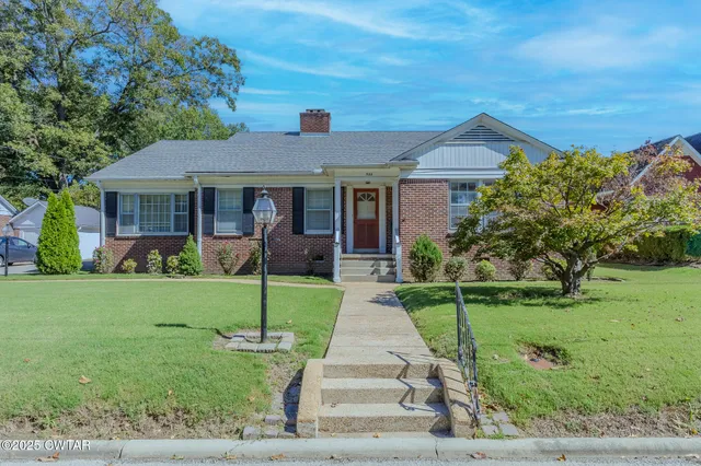 a front view of a house with a yard table and plants