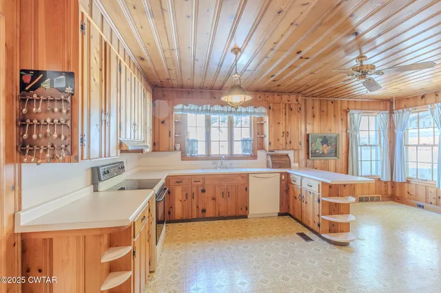 a large room with lots of counter space and wooden floor
