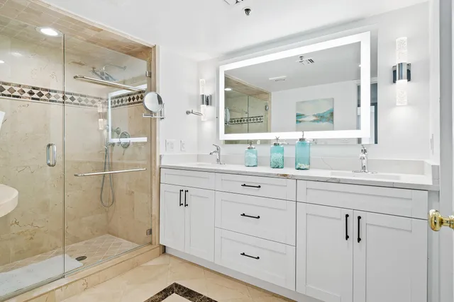 a bathroom with double vanity sinks and a mirror