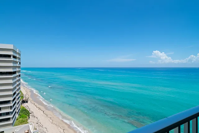 a view of a balcony with couches and wooden floor