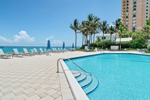 a swimming pool with outdoor seating and yard