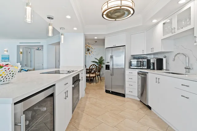 a kitchen with cabinets and chandelier