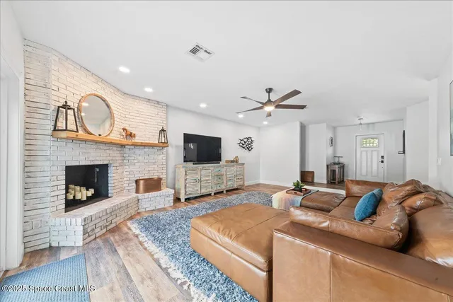 a spacious bedroom with a bed and a flat screen tv