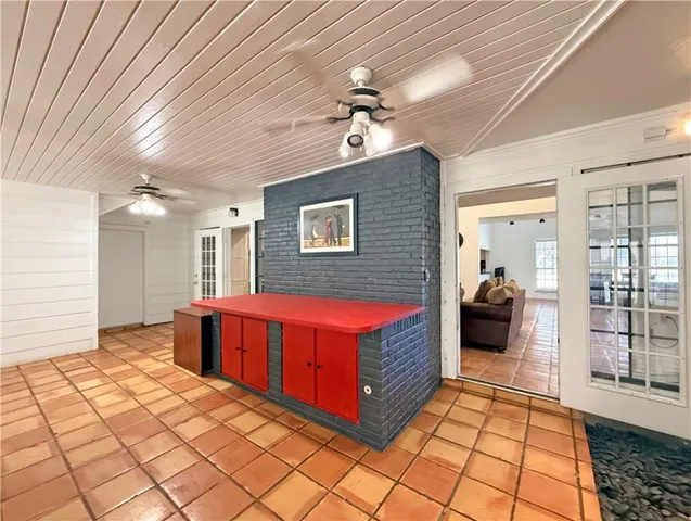 a spacious bedroom with a large bed and a chandelier