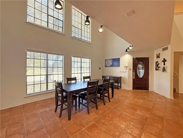 a view of a dining room with furniture and chandelier