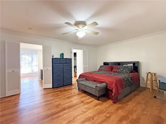 a spacious bedroom with a bed and a chandelier