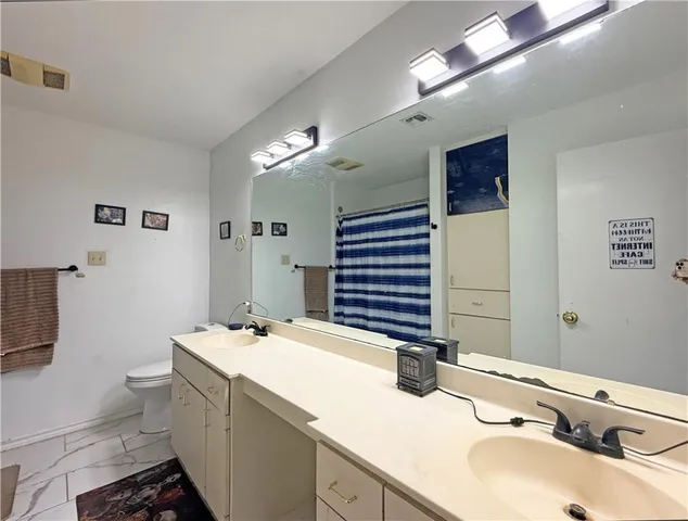 a bathroom with a double vanity sink and a mirror
