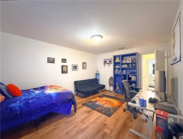 a bedroom with furniture and a book shelf