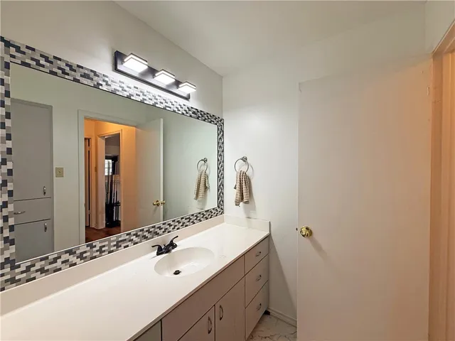 a bathroom with a sink and a mirror