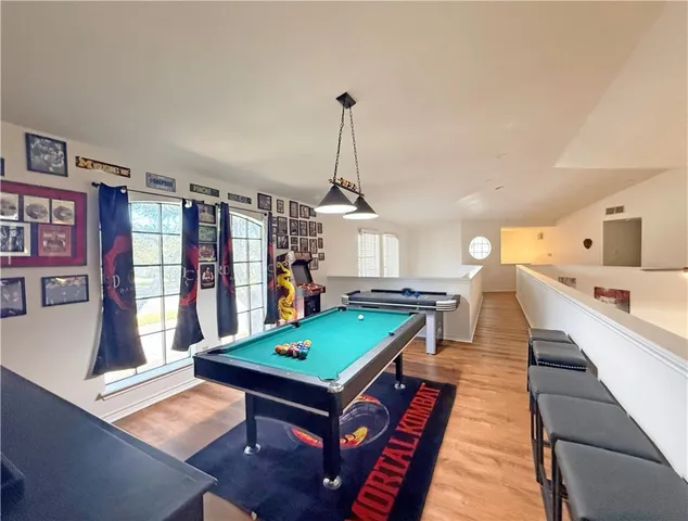 a room with lots of furniture and pool table