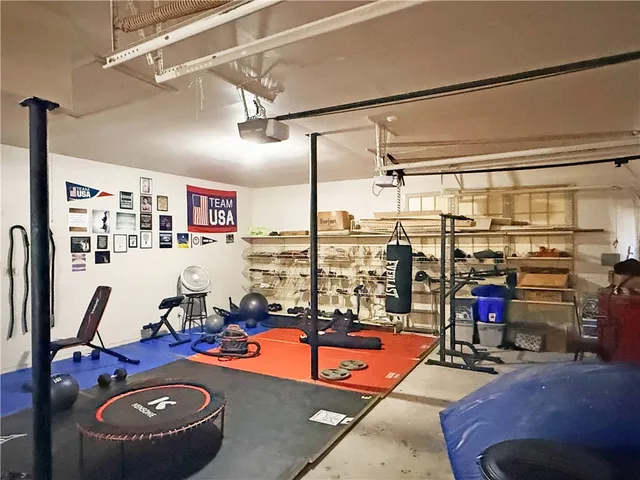 a room with gym equipment and a table
