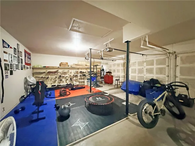 a room with gym equipment and a table