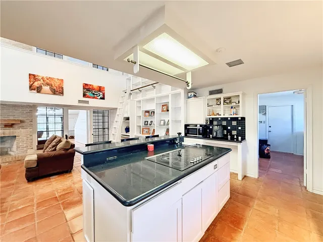 a kitchen with stainless steel appliances granite countertop a sink and a counter space