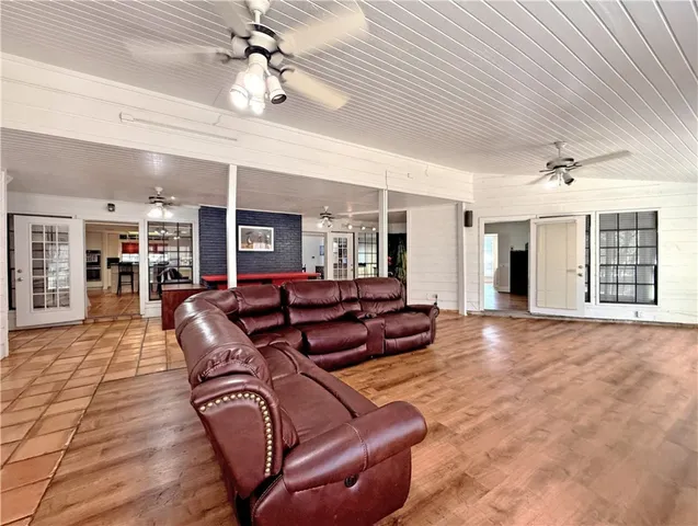 a living room with furniture a ceiling fan and a rug