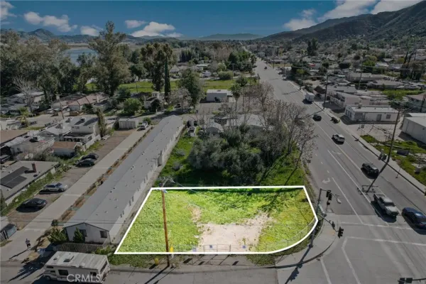 an aerial view of a residential houses with outdoor space and street view