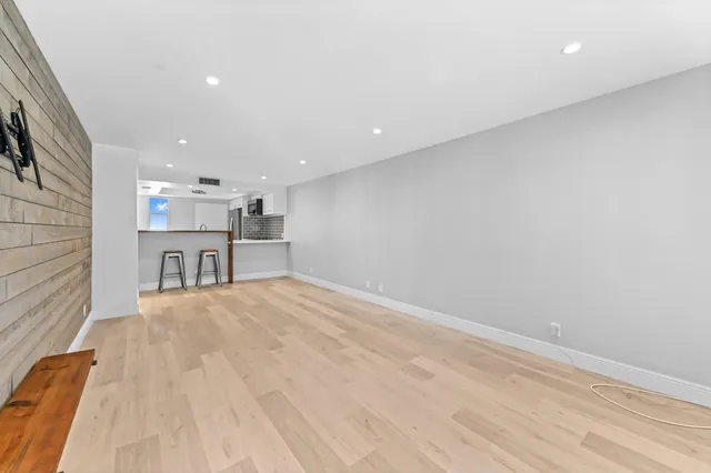 a view of a kitchen with a sink and a refrigerator
