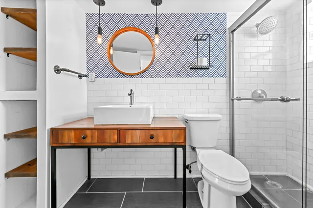 a bathroom with a toilet a sink and a mirror