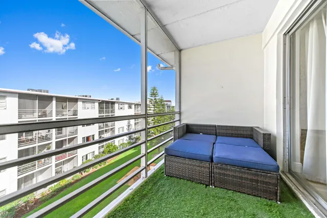 a wooden bench sitting in front of a building