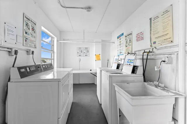 a kitchen that has a sink and a stove in it