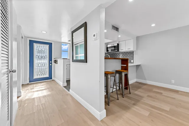 a view of kitchen with furniture and wooden floor