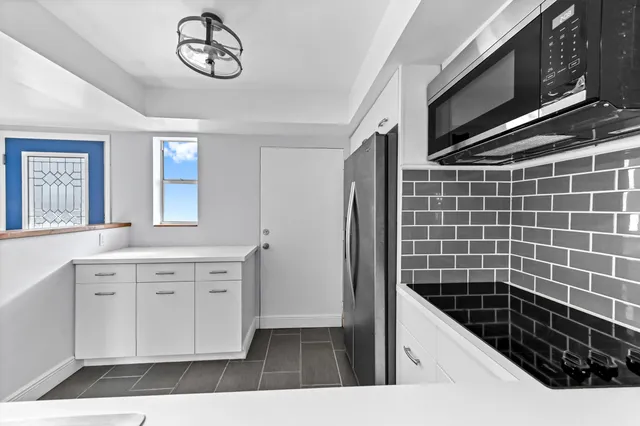 a bathroom with a sink a large mirror and a shower