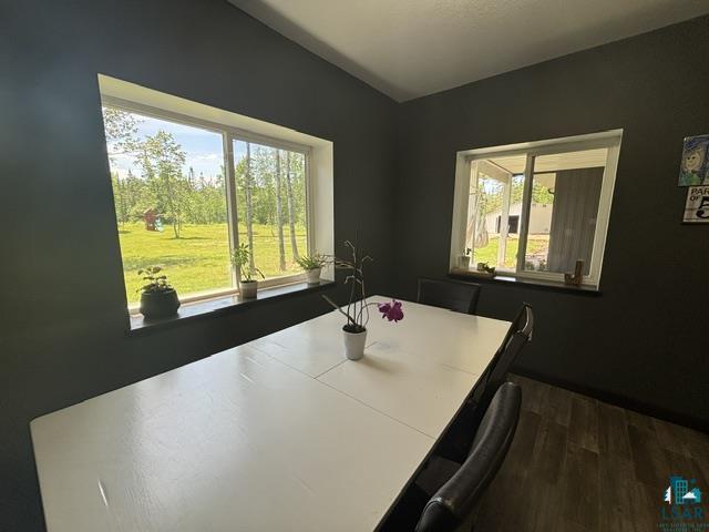 3454 Anderson Road Hibbing, MN 55746 - Photo 16 of 31 Interior space featuring dark accent walls and wood-finish flooring