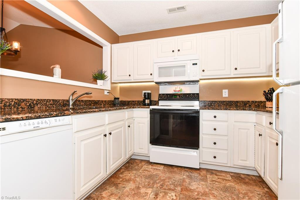 4406 Single Tree Lane High Point, NC 27265 - Photo 5 of 23 Bright white cabinets with lighting underneath