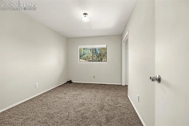 a view of a kitchen with white cabinets and a stove top oven