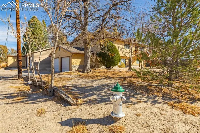 a view of a yard covered with snow in front of house